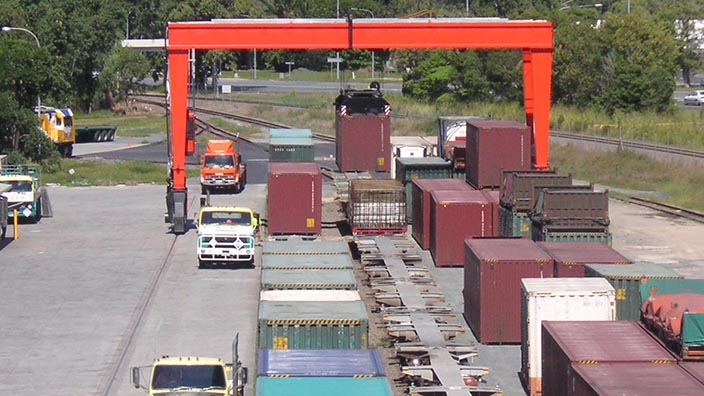 Isoloader Rubber Tired Gantries (RTG) used for train stripping and container storage in intermodal terminals.